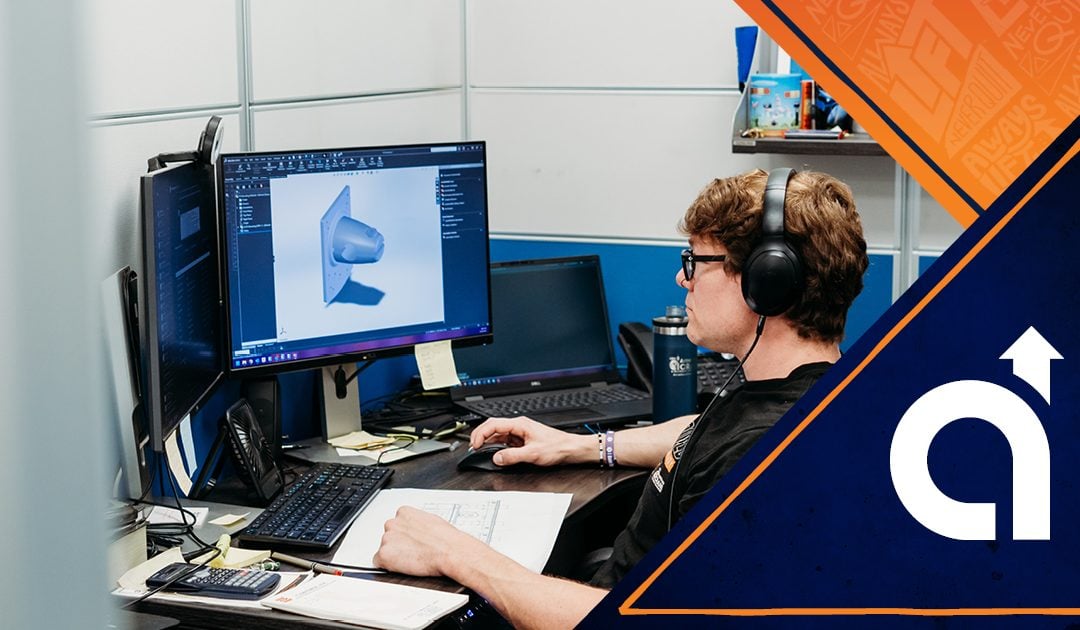 Engineer at American Crane working at his desk on a custom crane design project