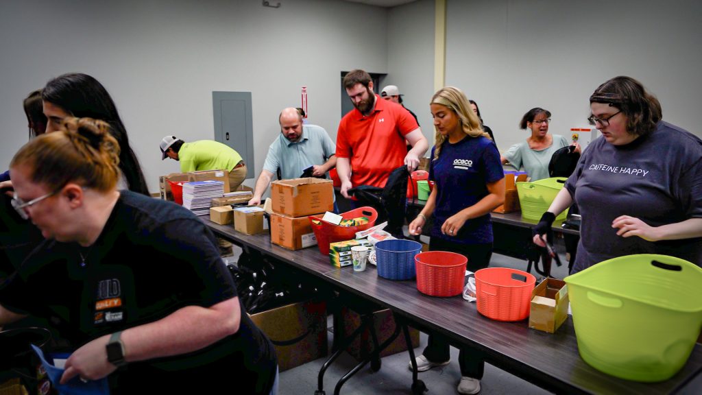 ACECO volunteers packing school supply backpacks for Hoist Up! initiative