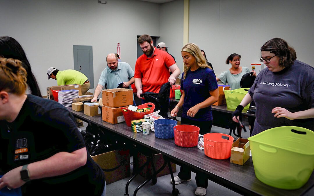 ACECO volunteers packing school supply backpacks for Hoist Up! initiative